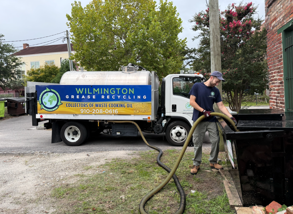 Used cooking oil and grease recycling service truck collecting waste cooking oil in Wilmington, NC.