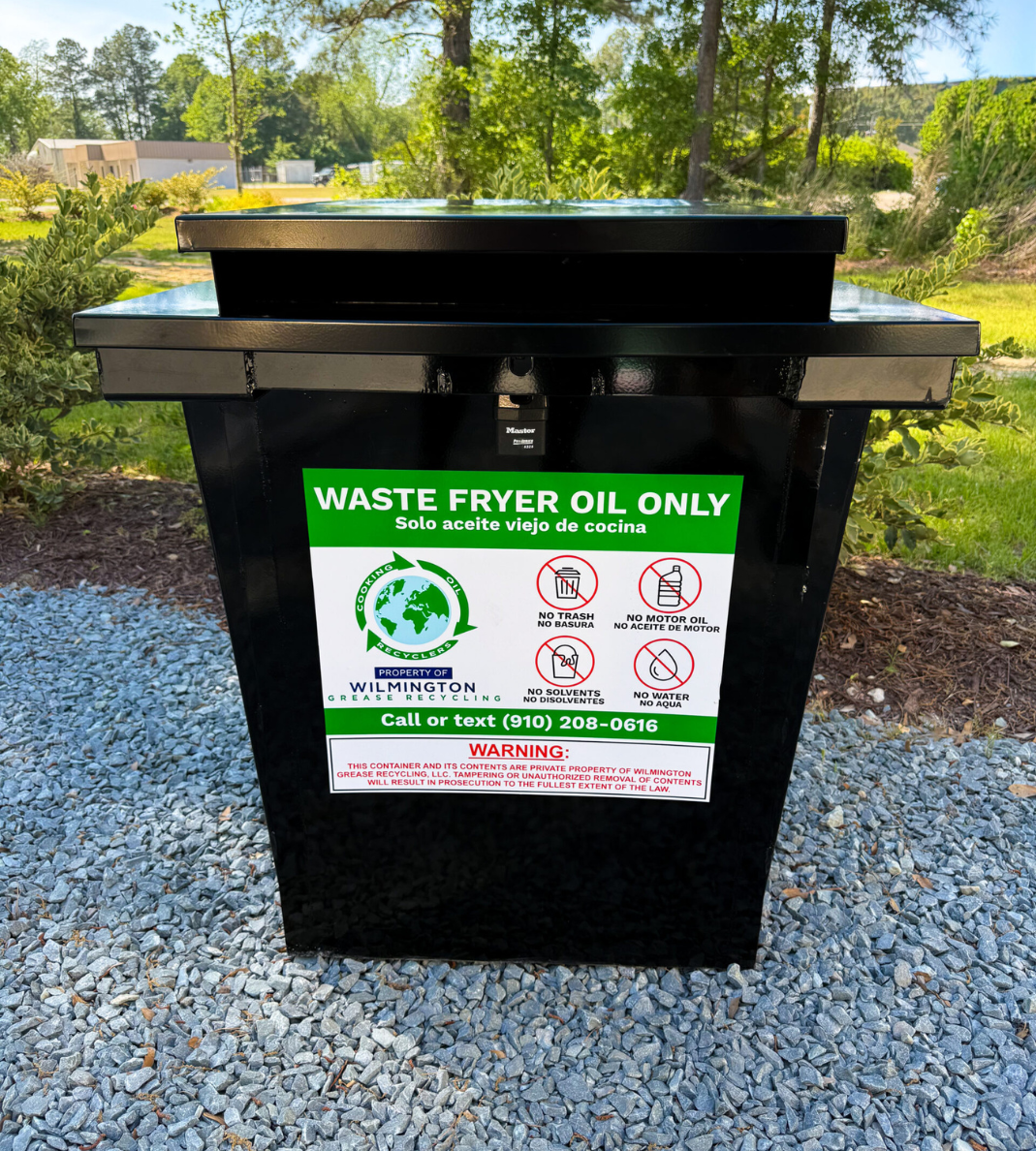 Grease Container & Bin Management 7 Black waste fryer oil recycling container labeled for used cooking oil collection, shown outdoors on a gravel surface.